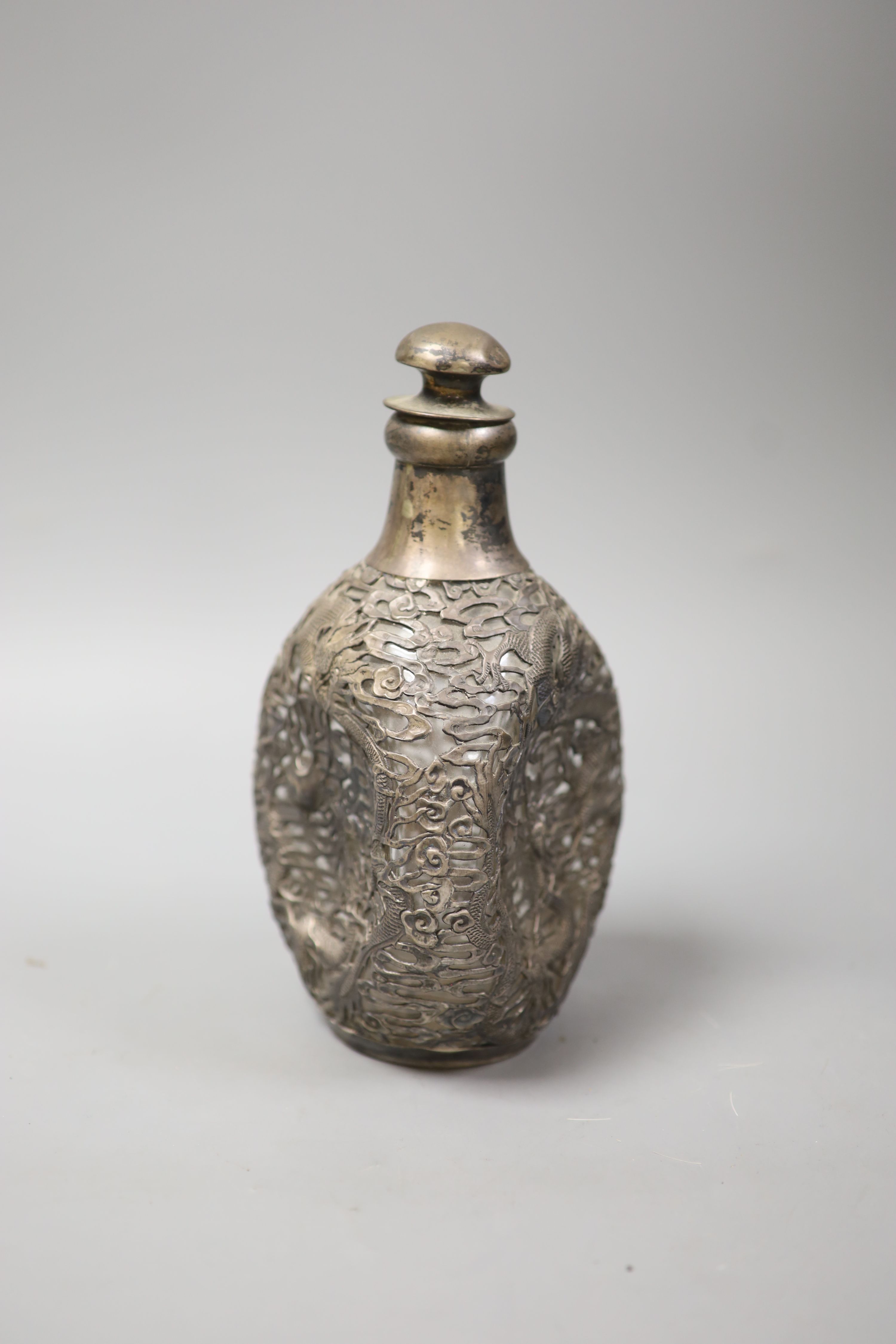 A Chinese pierced white metal mounted dimpled decanter with stopper